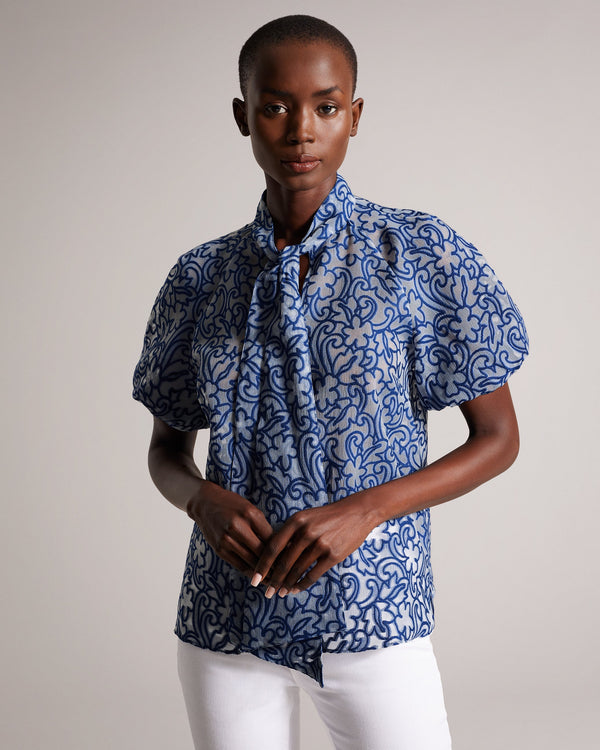 MELODIY-Tops-Add a touch of texture and colour to your outfit with the dreamy MELODIY top. Its paisley design is sure to stand out, while puff sleeves and a neck tie enhance the silhouette. Boxy fit top Semi sheer Jacquard paisley design Short puff sleeves Oversized neck tie High neck Awuoi is 5'10.5" / 1.79m and wears Bright Blue in a Ted size 1- Ted Baker Romania