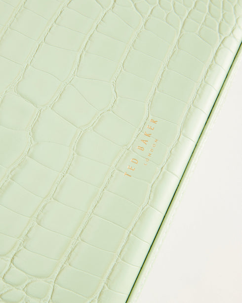 BRENDYY-Gifts-Fit your entire jewelry collection into the BRENDYY case with multiple storage compartments and a handy elasticated pocket. The zip around fastening makes it safe for travelling, and the faux leather outer is finished with a croc effect and branding detail for sleek style. Jewellery case Croc effect Faux leather upper Zip around fastening Multiple compartments Elasticated internal pocket Debossed branded detail Dimensions: 19cm x 23cm x 7cm- Ted Baker Romania