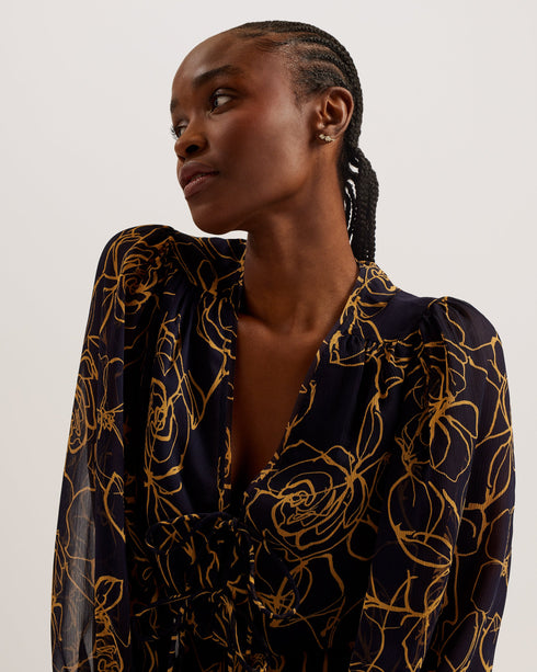 KAZUKO-Tops-This KAZUKO blouse is flowy, floral and fabulous. The sheer material is covered in an abstract floral print for a fun piece that will look good with both your work trousers and summer shorts. The peplum silhouette creates a flattering shape, accentuated by an elasticated waist and V neckline that fastens with double ties. Voluminous bishop sleeves complete this top for a feminine feel. Peplum blouse Abstract floral print Double tie front Sheer finish with lined bust V-neck Long bishop sleeves El