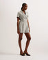 OSAMUD-Tailoring-We're making tailored style fun again with OSAMUD. This romper cuts a flattering silhouette with a wide leg design and wrap over front, complete with a built-in belt to cinch the waist. The boucle texture combined with vintage look buttons create a classic look, finished off with flap pockets on the chest. Go from office wear to evening drinks in this playful number. Tailored romper Boucle texture Wrap over design Notch lapel collar Flap chest pockets Belted waist Shiny button fastenings Ly
