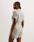 OSAMUD-Tailoring-We're making tailored style fun again with OSAMUD. This romper cuts a flattering silhouette with a wide leg design and wrap over front, complete with a built-in belt to cinch the waist. The boucle texture combined with vintage look buttons create a classic look, finished off with flap pockets on the chest. Go from office wear to evening drinks in this playful number. Tailored romper Boucle texture Wrap over design Notch lapel collar Flap chest pockets Belted waist Shiny button fastenings Ly