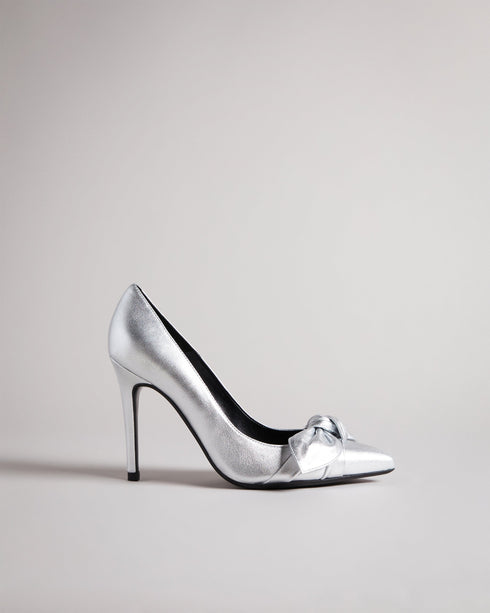 SILVEYY-Shoes-Get ready to bow down to your shoe collection with your latest addition, SILVEYY. The silver lining to any outfit, the classic court shoe can be worn to a wide range of events, while the bold metallic and elegant bow design allows these to take centre-stage of any outfit. 10cm heel Bow design Court shoe style Ted Baker-branded- Ted Baker Romania