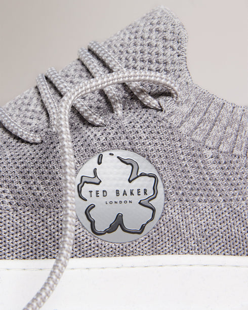 EDMOND-Sneakers-Put your best foot forward in EDMOND. These easygoing trainers have a knitted upper, lace up fastening and magnolia embellishment to keep you looking on point all day long, while the rubber sole provides a comfortable feel underfoot.The upper of this product is made of 100% recycled polyester. Using recycled polyester helps divert plastic waste from ending in landfills. Low top trainers Knitted upper Lace up Magnolia embellishment Rubber sole Ted Baker branded Comes in Ted Baker branded pack