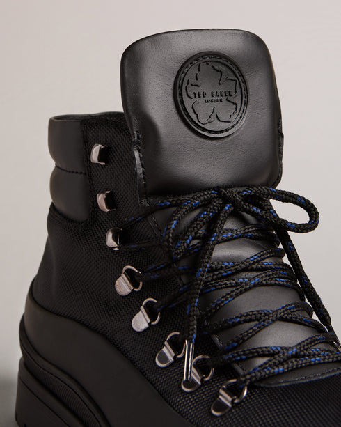 JAKSONN-Boots-Calling all adventure takers. JAKSONN are great shoes for the outdoors that don't compromise on style. The leather and nylon upper gives these boots a more refined look than your average hiking boots, while the rubber sole adds durability and traction. By purchasing this product, you are supporting responsible leather manufacturing through the Leather Working Group. Hiking boots Leather and nylon upper Rubber sole Lace up Ted Baker branded Padded ankle Comes in Ted Baker branded packaging- Ted