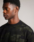TUGO-Tops-Made from 100% cotton and in a relaxed fit, TUGO perfect for weekend lounging. This quirky camo tee features a relaxed fit, crew neck and short sleeves. Team with jeans and trainers for an easy weekend look.By choosing Ted Baker cotton products, you're supporting our investment in the Better Cotton Initiative's mission. This product is sourced via a system of mass balance and therefore may not contain Better Cotton. T-shirt 100% cotton Relaxed fit Camo jigsaw print Short sleeved Crew neck Grace is