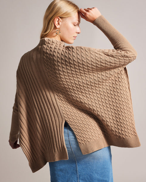 JOILLA-Knitwear-The JOILLA jumper features a funnel neck and long sleeves, with split sides for a unique look. Crafted from a wool and cashmere blend, it is the perfect layer to take you through the winter months. This wardrobe essential works just as well paired with jeans as it does under your favourite leather skirt. The fabric of this product is made with 35% recycled polyamide and 16% recycled wool. Using recycled materials helps divert fabric waste from ending in landfills and reduces our dependence o