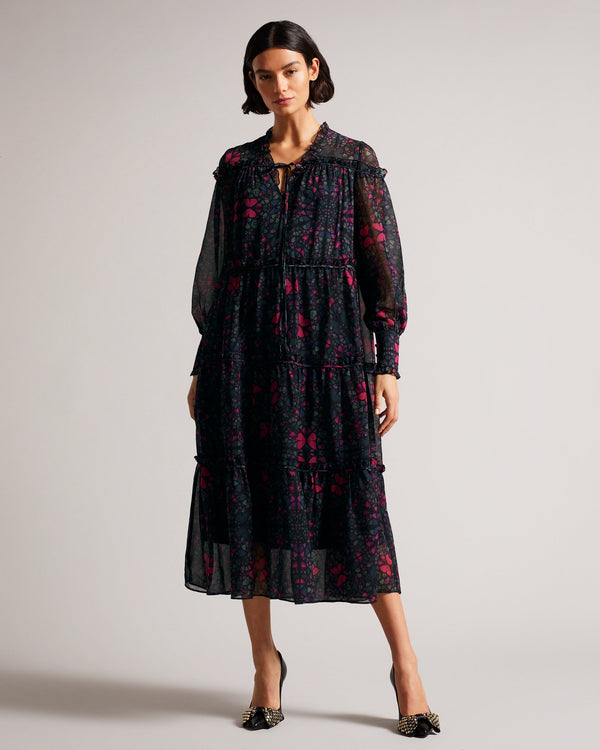 ELLYAH-Dresses-Make an entrance in ELLYAH. A floaty tieres dress with subtle ruffles and our kaleidoscope buttefly print all over, this ethereal maxi will wow at the bar, the park or at festive events.The fabric of this product is made with 55% recycled polyester. Using recycled polyester helps divert plastic waste from ending in landfills and helps us to reduce our dependancy on virgin materials. Swing dress Midaxi length Long sleeved Tiered with ruffle details V-neck Kaleidoscope butterfly print Anna is 5
