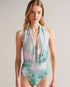 MILENE-Swimwear-One piece, a whole lot of style. The MILENE swimsuit is a versatile piece with multiple ways to wear. Its self-tie detail makes it easy to ensure a secure fit while the abstract print keeps it fun and eye-catching. Swimming costume One piece Multiple ways to wear Self tie Abstract print Roos is 5'11" / 1.80m and wears Green in a Ted size 1- Ted Baker Romania
