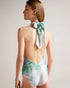 MILENE-Swimwear-One piece, a whole lot of style. The MILENE swimsuit is a versatile piece with multiple ways to wear. Its self-tie detail makes it easy to ensure a secure fit while the abstract print keeps it fun and eye-catching. Swimming costume One piece Multiple ways to wear Self tie Abstract print Roos is 5'11" / 1.80m and wears Green in a Ted size 1- Ted Baker Romania