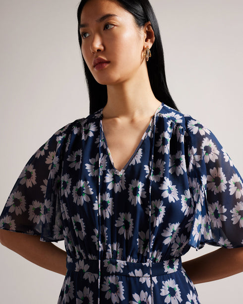 MARLLEE-Dresses-Introducing MARLLEE, your new wardrobe essential. With its sophisticated design and attention-grabbing details, this midi dress is bound to make a statement. Adorned with a stunning painted floral print and featuring short fluted sleeves, it boasts a floaty A-line silhouette that exudes elegance. Style it with heels for an elegant outing with friends or pair it with ankle boots for the daytime.The shell of this product is made of 100% recycled polyester. Using recycled polyester helps divert