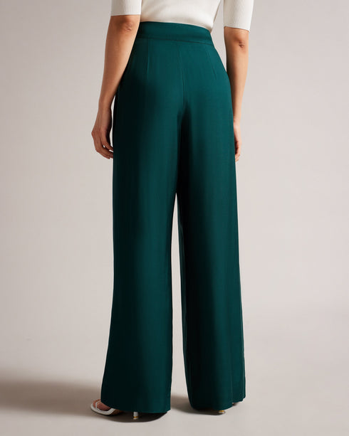 KRISSI-Trousers-The KRISSI wide leg trousers are a must-have item in any wardrobe. Crafted with a high rise and tailored shape, this staple is wonderfully versatile. Team with heels for evening attire, or trainers for elevated street style. Trousers Wide leg High rise Leg pleats Concealed fastening Chae is 5'9.5" / 1.77m and wears Dark Green in a Ted size 1- Ted Baker Romania