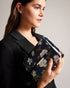 JENIA-Bags-Perfect for adding a pop of colour to any outfit, JENIA features a beautiful floral print and a versatile chain shoulder strap for a chic and convenient way to carry your essentials. Its push lock closure adds a touch of sophistication to complete the look, so you can wow from the office to the bar. Crossbody bag Chain shoulder strap Floral print Push lock closure Logo engraved hardware Dimensions: 7cm x 13cm x 20cm- Ted Baker Romania