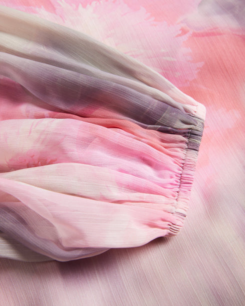 EMILIAH-Tops-Add some spring florals to your wardrobe with our EMILIAH blouse, which features a wrap front and blouson sleeves. Smocked shoulders give the piece extra texture without the bulk.The fabric of this product is made with 100% recycled polyester. Using recycled polyester helps divert plastic waste from ending in landfills, and helps us to reduce our dependence on virgin materials. Blouse Wrap front Blouson sleeves Smocked shoulders Blurred floral print Self tie waist V-neck Julia is 5'10" / 1.78m