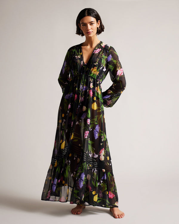 ZENNIE-Swimwear-This long sleeved ZENNIE cover up is perfect for days spent by the pool or beach. We love the scattering of florals on the floaty fabric, and the loop lace trim that adds a subtle touch of femininity.The shell of this product is made of 100% recycled polyester. Using recycled polyester helps divert plastic waste from ending in landfills and helps us to reduce our dependency on virgin materials. Maxi cover up A-line Scattered bouquet print V-neck Long sleeved Loop lace trim Anna is 5'10" / 1.