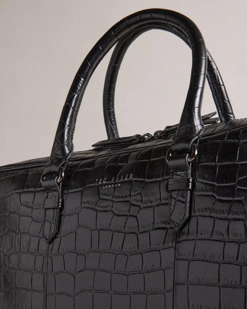 FABIANN-Bags-The FABIANN document bag blends style and functionality with effortless finesse. Inside, you'll find a padded pocket designed to fit a 15" laptop and a trolley slip that makes it the ideal travel companion for business trips and beyond. Document bag Croc effect leather Removable twill shoulder strap Two top handles Zip fastening Ted Baker logo Trolley slip Padded pocket fits 15" laptop Dimensions: 40cm x 8cm x 28cm- Ted Baker Romania