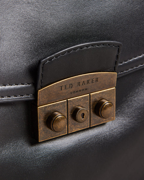 KALSIN-Bags-Keen travellers take note, KALSIN answers all your luggage woes. With its sleek design, spacious interior, and thoughtful features, this duffle bag effortlessly combines style and functionality. Duffle bag Top grain leather Zip fastening Two top handles Front pocket with trunk lock hardware Adjustable shoulder strap Dimensions: 45cm x 21cm x 24cm- Ted Baker Romania