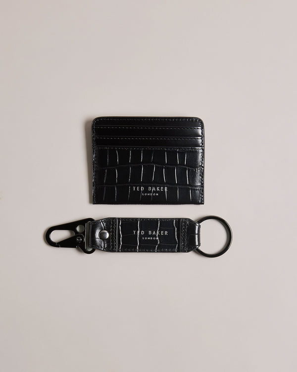 ROMAIIN-Gifts-Keep your keys and cards organized with our ROMAIIN set. Made from high-quality leather featuring a sophisticated croc texture, these accessories are the epitome of understated luxury. With a glossy finish that catches the eye, this set not only keeps your essentials in check but also adds a stylish edge to your everyday carry. Key fob and card holder set Leather Croc texture Hinge clip Logo detail Glossy finish- Ted Baker Romania