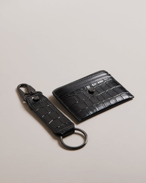 ROMAIIN-Gifts-Keep your keys and cards organized with our ROMAIIN set. Made from high-quality leather featuring a sophisticated croc texture, these accessories are the epitome of understated luxury. With a glossy finish that catches the eye, this set not only keeps your essentials in check but also adds a stylish edge to your everyday carry. Key fob and card holder set Leather Croc texture Hinge clip Logo detail Glossy finish- Ted Baker Romania