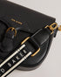 ESIA-Bags-Effortless glamour, meet ESIA. This saddle bag is crafted from luxurious leather, and you can keep even more essentials close at hand with the convenient back slip pocket. For a personalised touch, the removable branded webbing strap allows you to switch up your look effortlessly. Leather crossbody saddle bag Magnetic fastening with buckle tab Chain shoulder strap with padded leather panel Removable branded webbing strap Logo hardware Back slip pocket Dimensions: 5cm x 16.5cm x 21cm- Ted Baker Rom