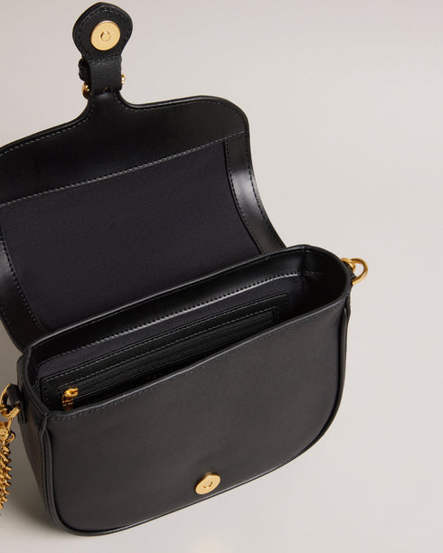 ESIA-Bags-Effortless glamour, meet ESIA. This saddle bag is crafted from luxurious leather, and you can keep even more essentials close at hand with the convenient back slip pocket. For a personalised touch, the removable branded webbing strap allows you to switch up your look effortlessly. Leather crossbody saddle bag Magnetic fastening with buckle tab Chain shoulder strap with padded leather panel Removable branded webbing strap Logo hardware Back slip pocket Dimensions: 5cm x 16.5cm x 21cm- Ted Baker Rom