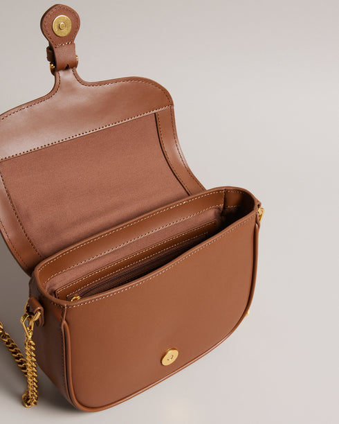 ESIA-Bags-Effortless glamour, meet ESIA. This saddle bag is crafted from luxurious leather, and you can keep even more essentials close at hand with the convenient back slip pocket. For a personalised touch, the removable branded webbing strap allows you to switch up your look effortlessly. Leather crossbody saddle bag Magnetic fastening with buckle tab Chain shoulder strap with padded leather panel Removable branded webbing strap Logo hardware Back slip pocket Dimensions: 5cm x 16.5cm x 21cm- Ted Baker Rom