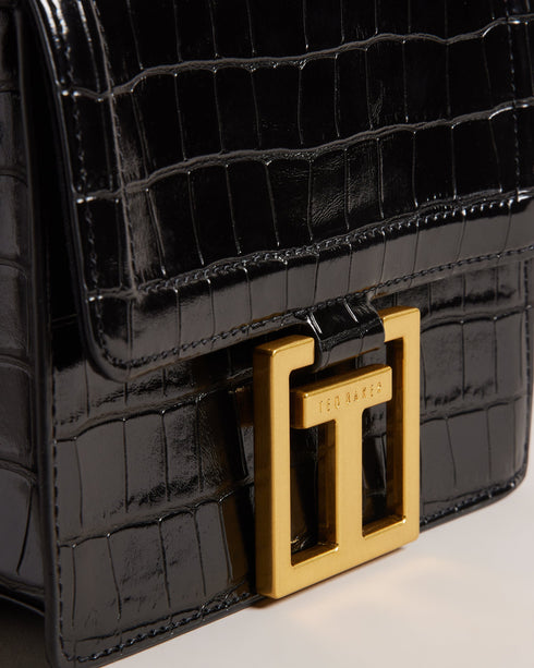 AALICCE-Bags-Whether You're Heading To A Brunch Date Or A Night Out With Friends The Aalicce Bag Is The Ideal Companion To Elevate Your Style And Keep Your Essentials Close At Hand. Crafted From High-quality Faux Leather With A Chic Croc Texture This Crossbody Features A Bamboo Top Handle And Statement Hardware For A Modern Edge. Crossbody bag Faux leather Croc texture Bamboo top handle Statement T hardware Adjustable shoulder strap Dimensions: 5.5cm x 15cm x 18cm- Ted Baker Romania