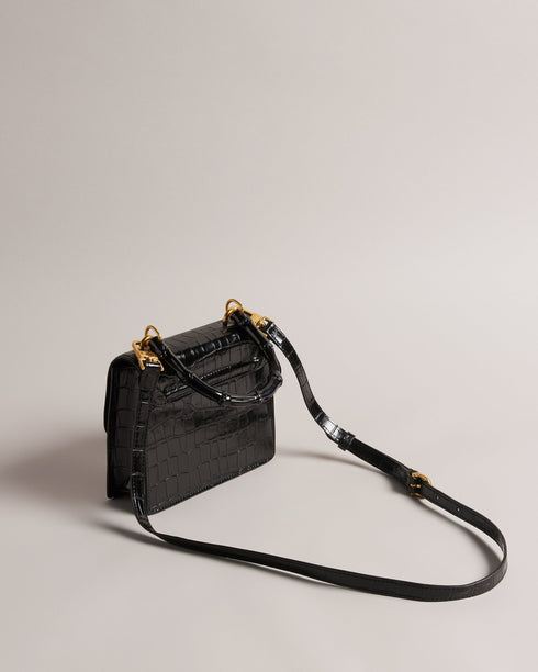 AALICCE-Bags-Whether You're Heading To A Brunch Date Or A Night Out With Friends The Aalicce Bag Is The Ideal Companion To Elevate Your Style And Keep Your Essentials Close At Hand. Crafted From High-quality Faux Leather With A Chic Croc Texture This Crossbody Features A Bamboo Top Handle And Statement Hardware For A Modern Edge. Crossbody bag Faux leather Croc texture Bamboo top handle Statement T hardware Adjustable shoulder strap Dimensions: 5.5cm x 15cm x 18cm- Ted Baker Romania