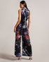 MARLEEH-Trousers-Dress to impress in MARLEEH. Featuring an oversized neck tie and a fitted waist, this sleeveless jumpsuit offers a sophisticated and flattering fit. Satin jumpsuit Floral print Wide leg Sleeveless Oversized neck tie Stand collar Fitted waist Zip fastening Samruddhi is 5'7" / 1.71m and wears Black in a Ted size 1- Ted Baker Romania