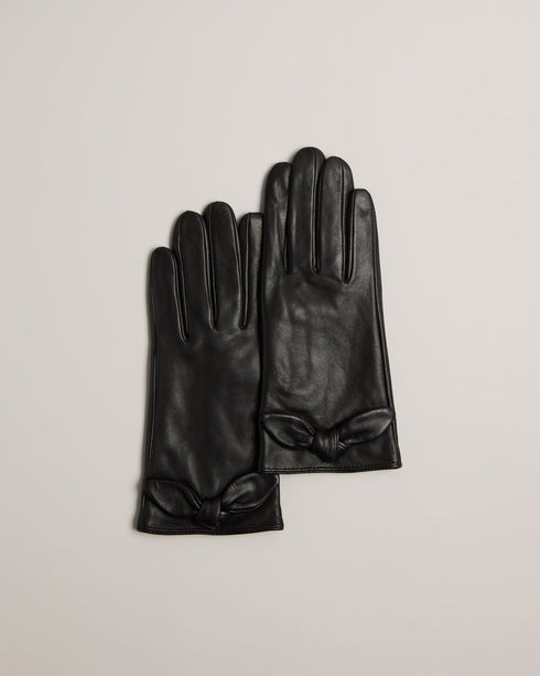 SOPHIIS-Gloves-Embrace the finer things in life with our beautifully crafted SOPHIIS gloves. Adorned with a charming knotted bow, they're a simple yet elegant way to warm up your look. Gloves Top grain leather Knotted bow embellishment Notched edge with magnolia studs- Ted Baker Romania