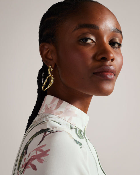 TTAYLA-Dresses-What's better than one floral print? TTAYLA. This shirt dress features our gorgeous floral collage print in a floaty easy-wearing silhouette. Midi dress Floral collage print Long shirt sleeves Waist tie Stand collar Concealed button placket Length: 126cm Ayo is 5'8" / 1.73m and wears Ivory in a Ted size 1- Ted Baker Romania