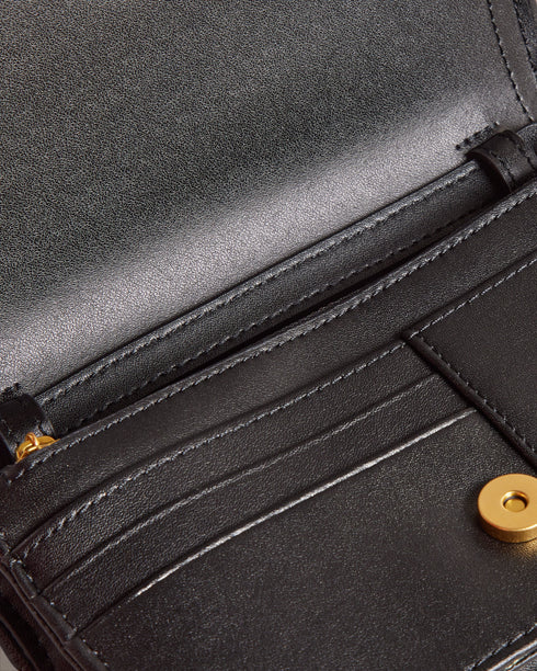 KAHNISA-goods-Carry around your card collection with KAHNISA. This leather purse has all of the card slots and zip compartments you'll ever need, with a fold over cover to keep them safe. The adjustable chain & leather shoulder strap allows for stylish carrying, finished with a studded trim for maximum style. Leather purse Studded trim Zip coin compartment Multiple card slots Foldover cover with magnetic fastening Adjustable chain and leather shoulder strap External zip pocket Dimensions: 10.5cm x 2.5cm- Te