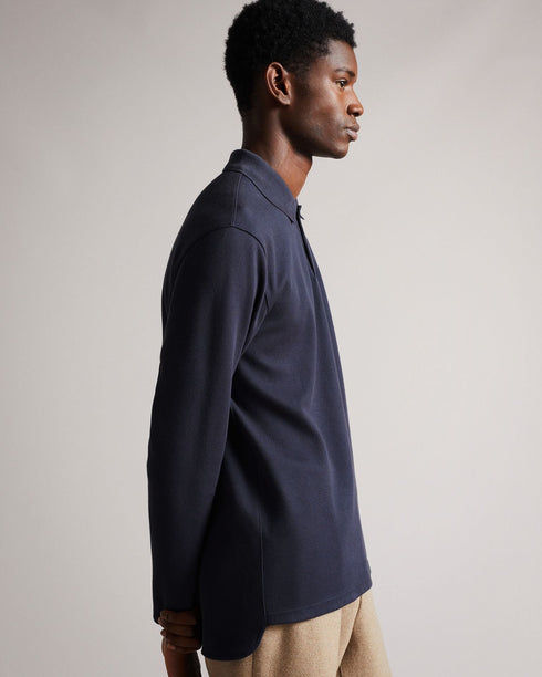 BADDOW-Tops-Hey, smooth operator. The BADDOW polo shirt is crafted from solid cotton twill, detailed with a buttoned collar and embroidered logo at the sleeve. Classic and comfy – it's perfect shirt for days in the office. The fabric of this product is made of organic cotton. Organic cotton has a proven lower environmental impact than conventional cotton, as it reduces water usage, greenhouse gas emissions, and eliminates the use of harmful chemicals in the farming process. Twill polo shirt Made from cott