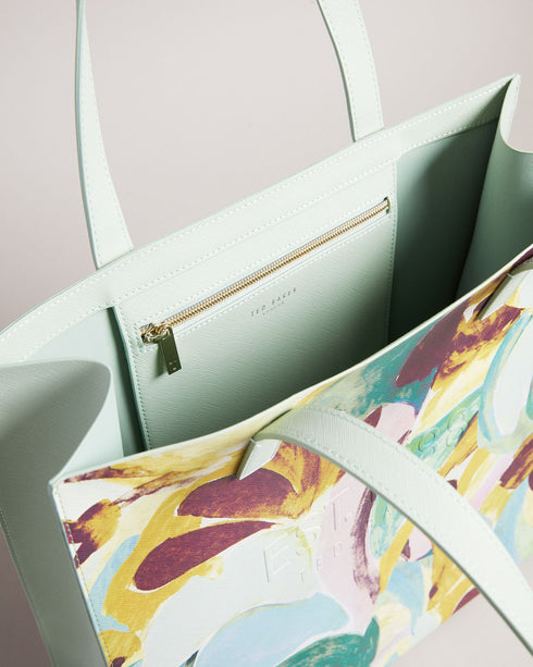 BRELCON-Bags-Hold your head high as you walk down the street with BRELCON. With a colorful brush stroke pattern, this shopper bag is sure to elevate your style game. This bag is complete with two top handles and an embossed Ted Baker branding. This product is made with 40% recycled polyester and 18% recycled polyurethane. Fabric made with recycled materials saves water and energy and helps divert waste from landfill. Large shopper bag Sand Dune brush strokes print Two top handles One internal pocket Embosse