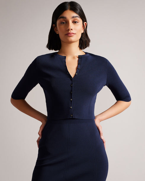 PERINE-Knitwear-Knits are having a moment. PERINE is a cropped cardigan with half-length sleeves and a button-up fastening that'll feel right at home in your wardrobe. Pair with a dress or your favourite jeans to take your look up a level. The fabric of this product is made with 64% recycled viscose. Using recycled materials helps divert fabric waste from ending in landfills and reduces our dependence on virgin materials. Ted Baker womenswear collection Rayon cardigan Cropped length Button fastening Half le