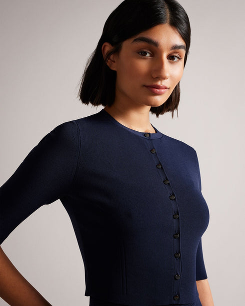 PERINE-Knitwear-Knits are having a moment. PERINE is a cropped cardigan with half-length sleeves and a button-up fastening that'll feel right at home in your wardrobe. Pair with a dress or your favourite jeans to take your look up a level. The fabric of this product is made with 64% recycled viscose. Using recycled materials helps divert fabric waste from ending in landfills and reduces our dependence on virgin materials. Ted Baker womenswear collection Rayon cardigan Cropped length Button fastening Half le